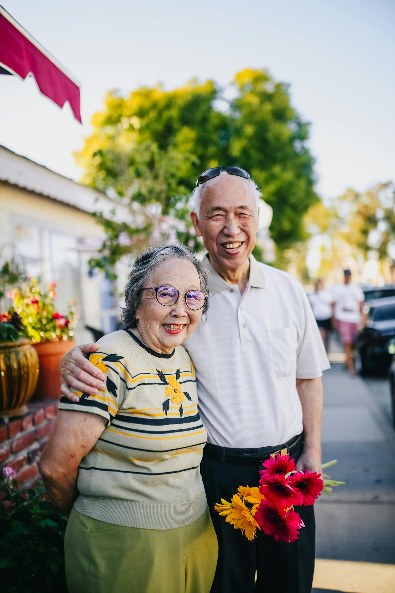 An elderly couple smiling in the wonderful sunshine.