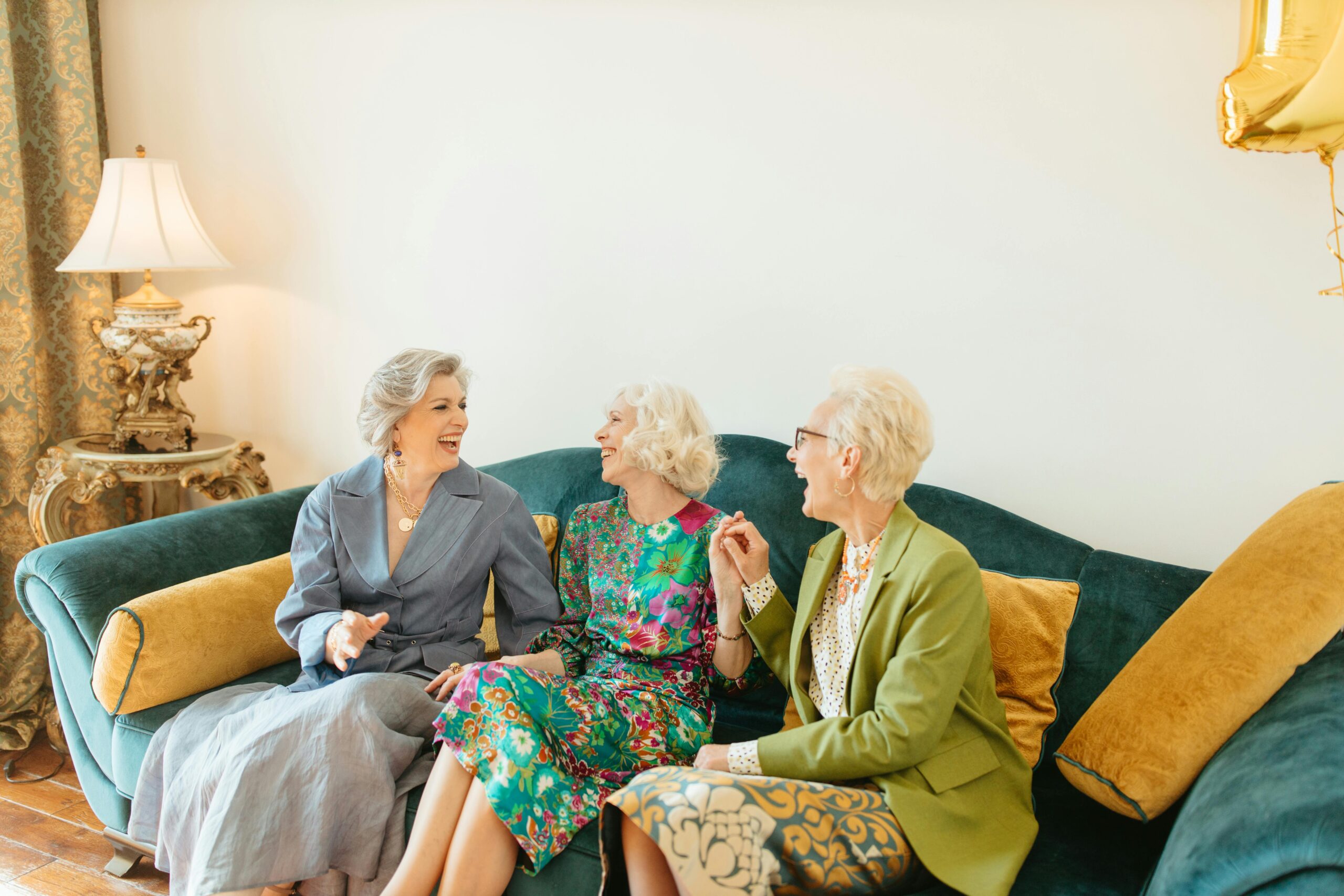 A group of three women laughing a the joke their male live in carer just told.